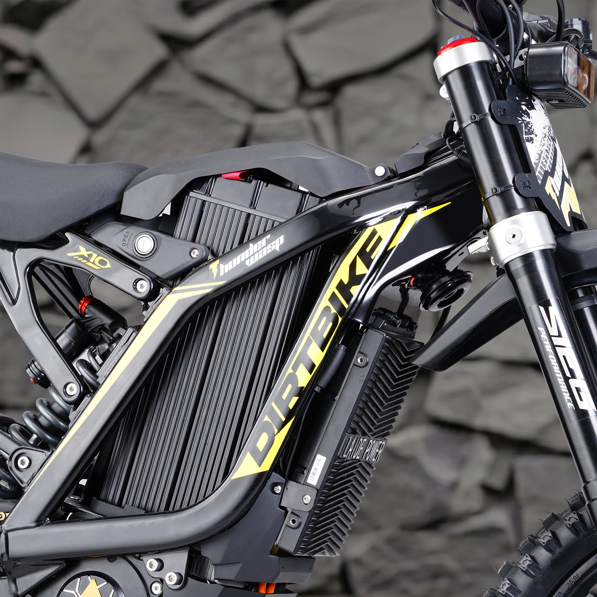 Close-up frame shot of X10 adult off-road electric dirt bike equipped with 72V 35Ah battery for 62 miles max range