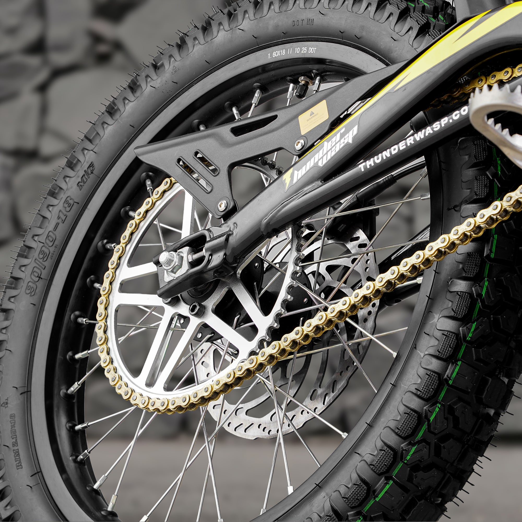 Detailed view of X10 high speed dirt ebike wear-resistant chain drive system and rugged rear offroad spoke wheel
