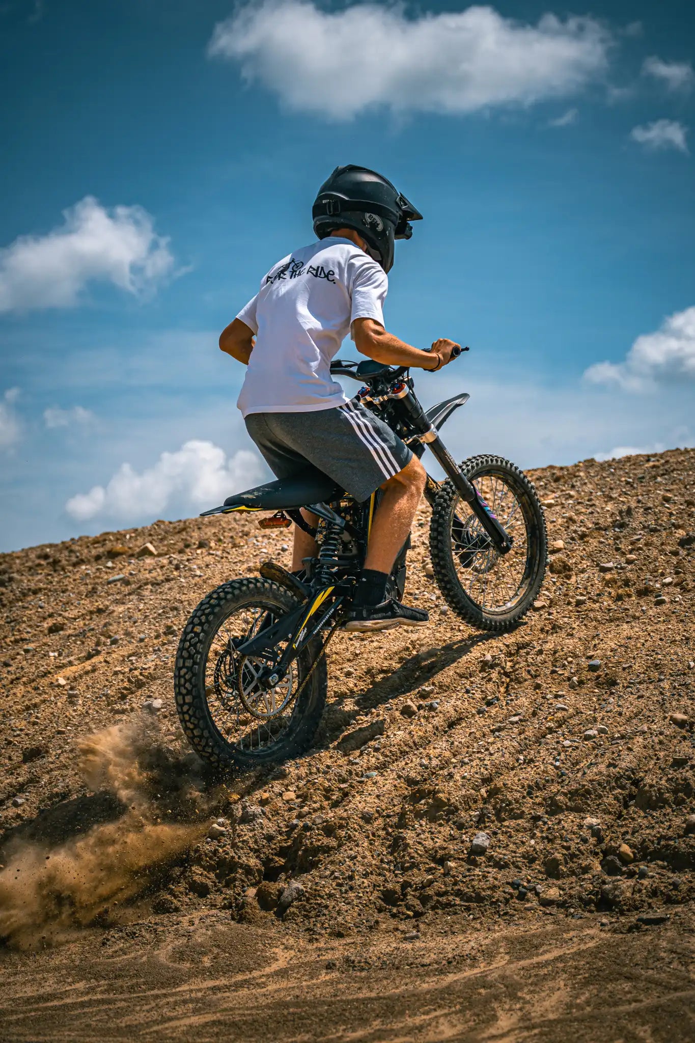 Adult enjoying offroad cruising on ThunderWasp XR16 responsive braking electric E-Moto in open dirt field