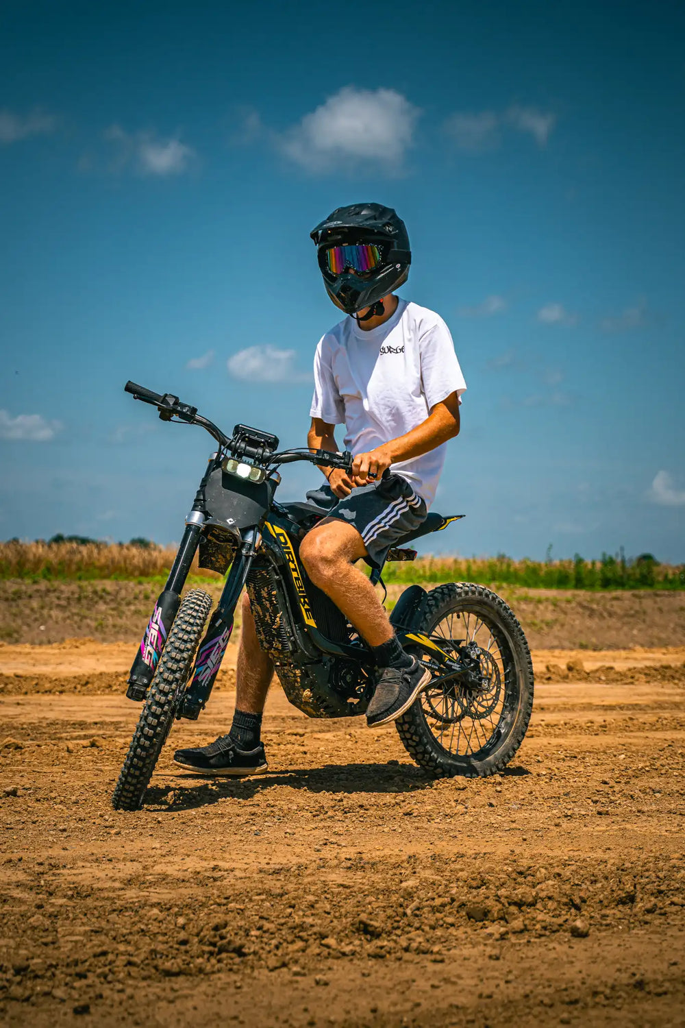 Left angle shot of adult rider controlling automotive-grade alloy ThunderWasp XR16 on dirt racing track